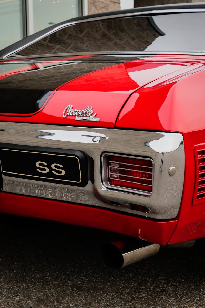 Close-up of a red Chevrolet Chevelle SS with shiny chrome details.