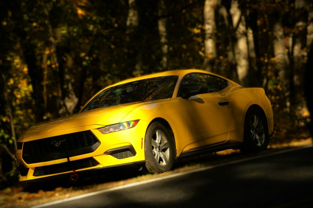 A yellow sports car parked on the side of the road