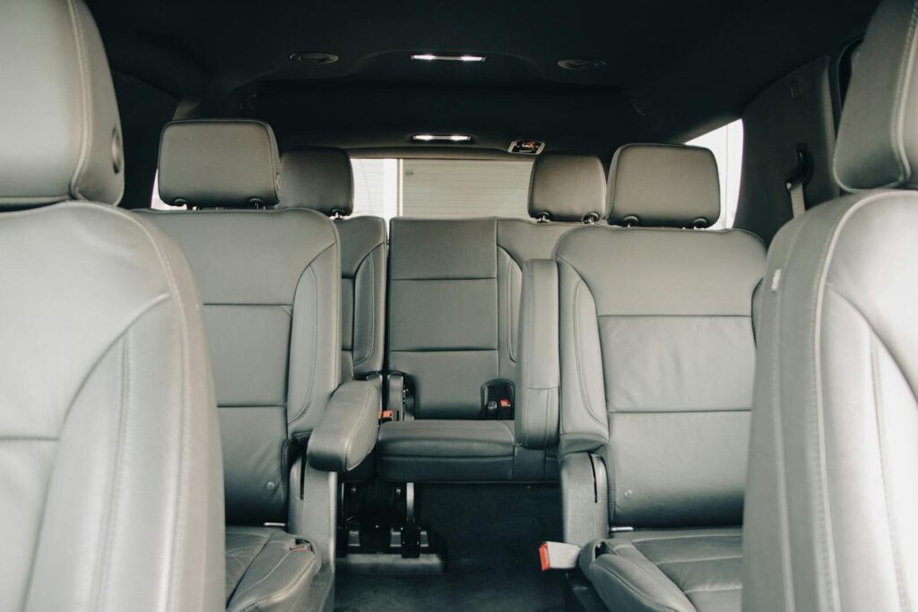 Explore the luxurious empty leather seats of a modern car interior, showcasing spacious design and comfort.