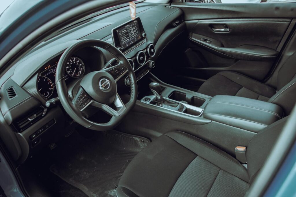 Explore the sleek interior of a Nissan Sentra featuring a modern dashboard and ergonomic design.