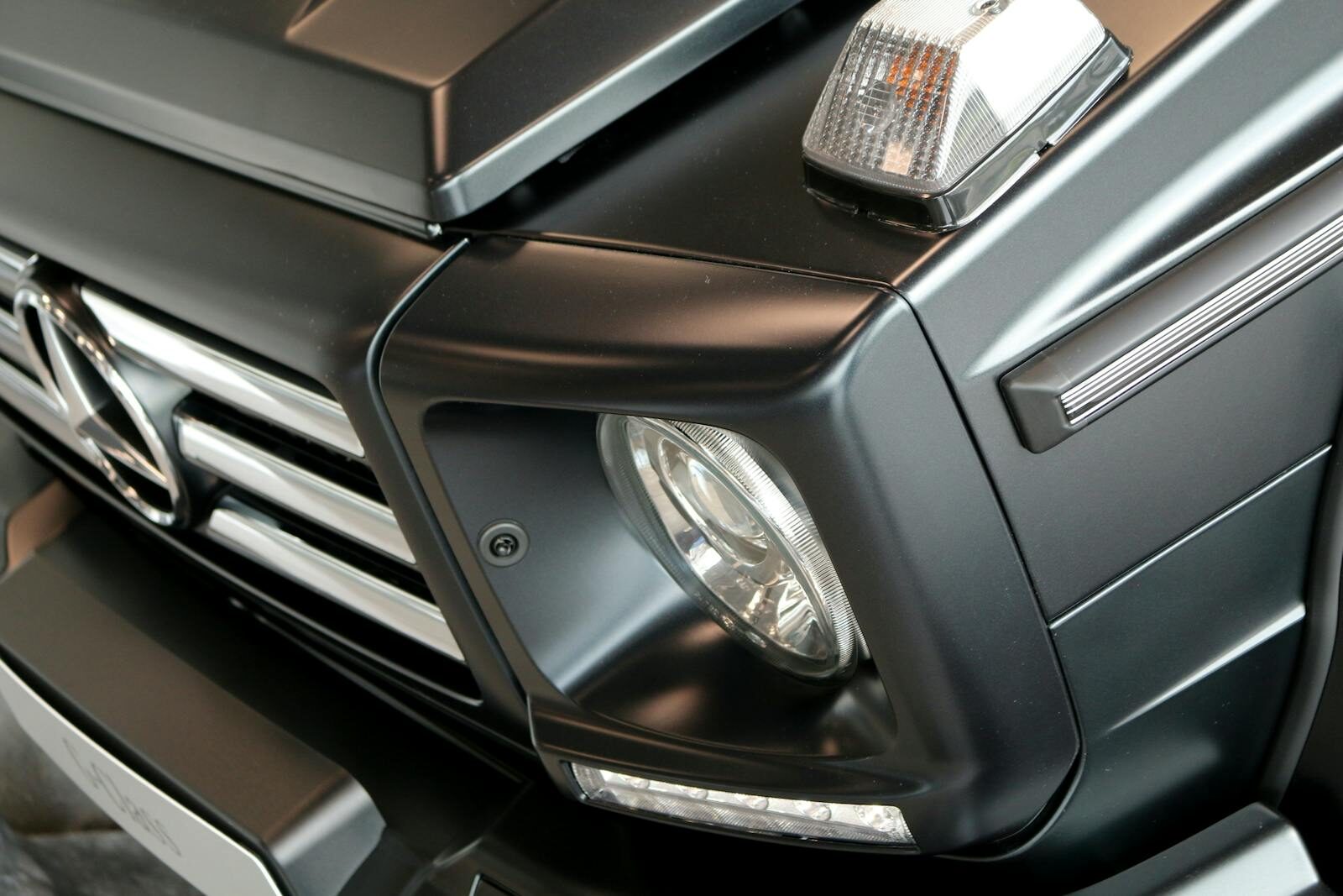 Detailed view of a luxury Mercedes vehicle's front with modern design and chrome elements.