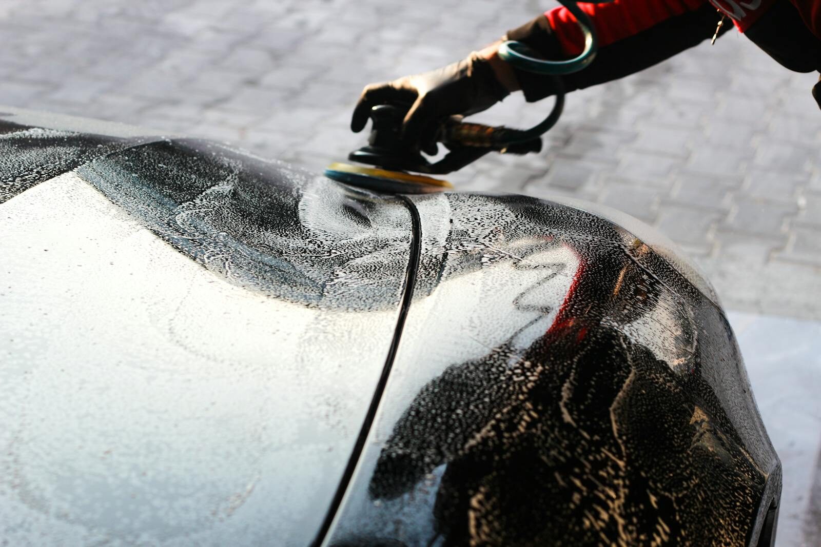 Photo by Orhun Rüzgar ÖZ Close-up of a car being polished by hand, showcasing professional detailing and maintenance.