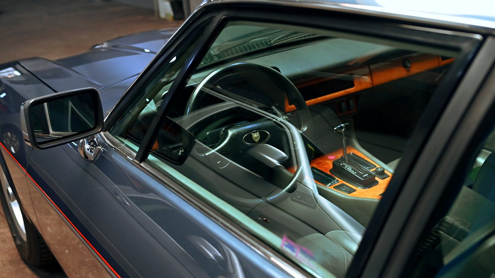 Photo by Luay Barani Interior of a vintage car with wooden accents.
