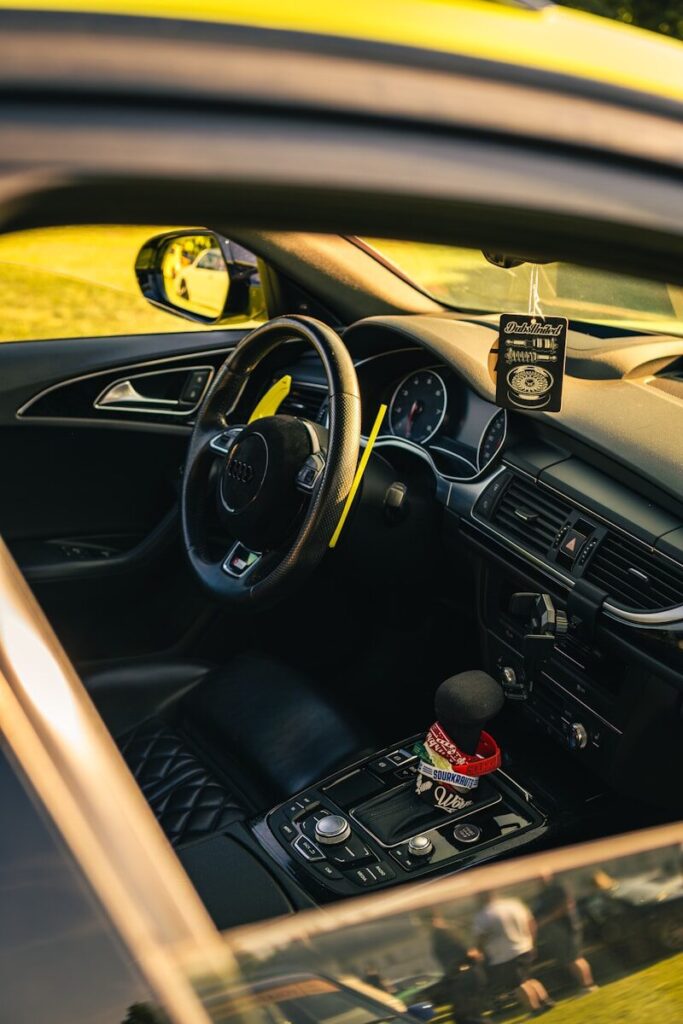 Interior view of a luxury car's dashboard and steering wheel.