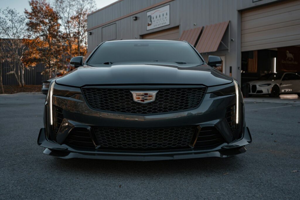 A black cadillac parked in front of a building