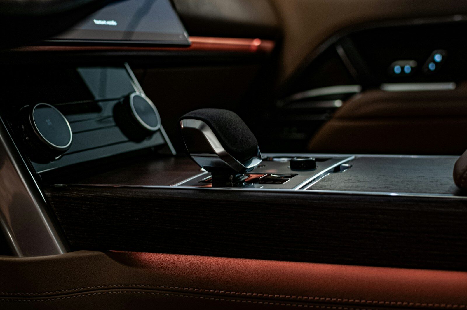 Photo by Olivie Zemanova A car dashboard with a phone and a car radio