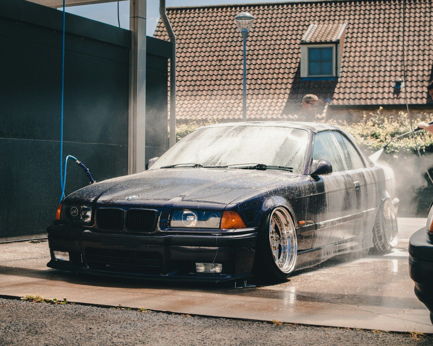 Photo by Ethan Sexton black BMW E36 on car wash