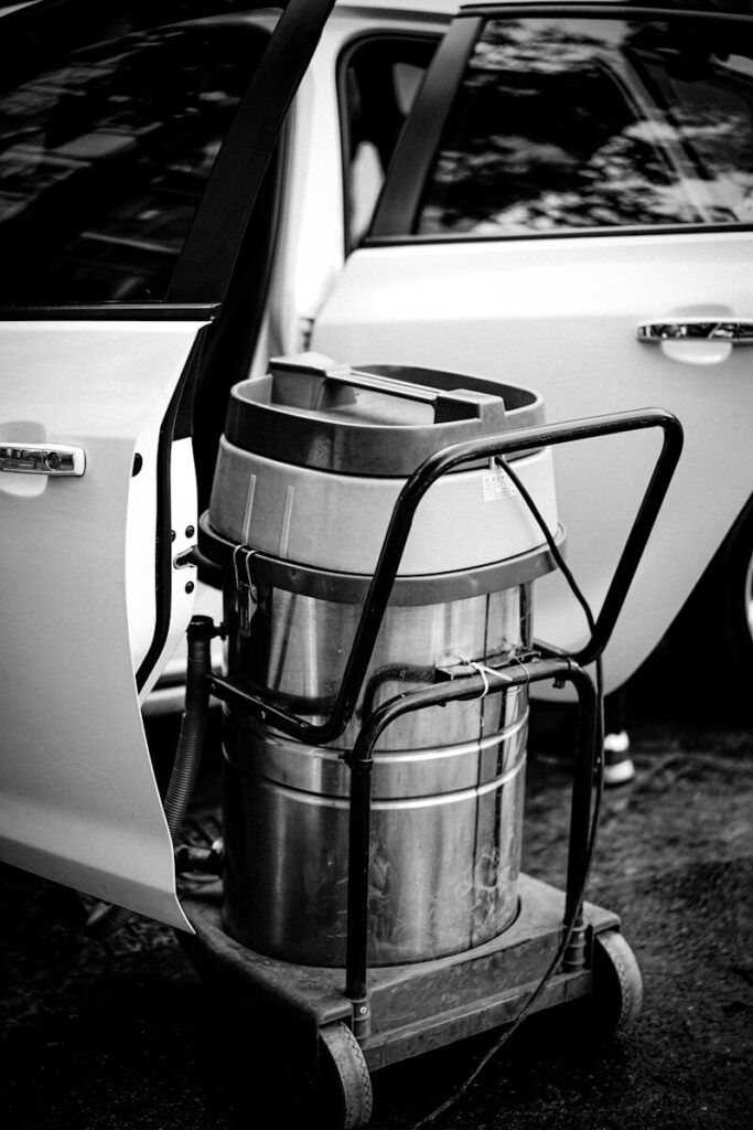 a black and white photo of a car with a cooler on the back of it