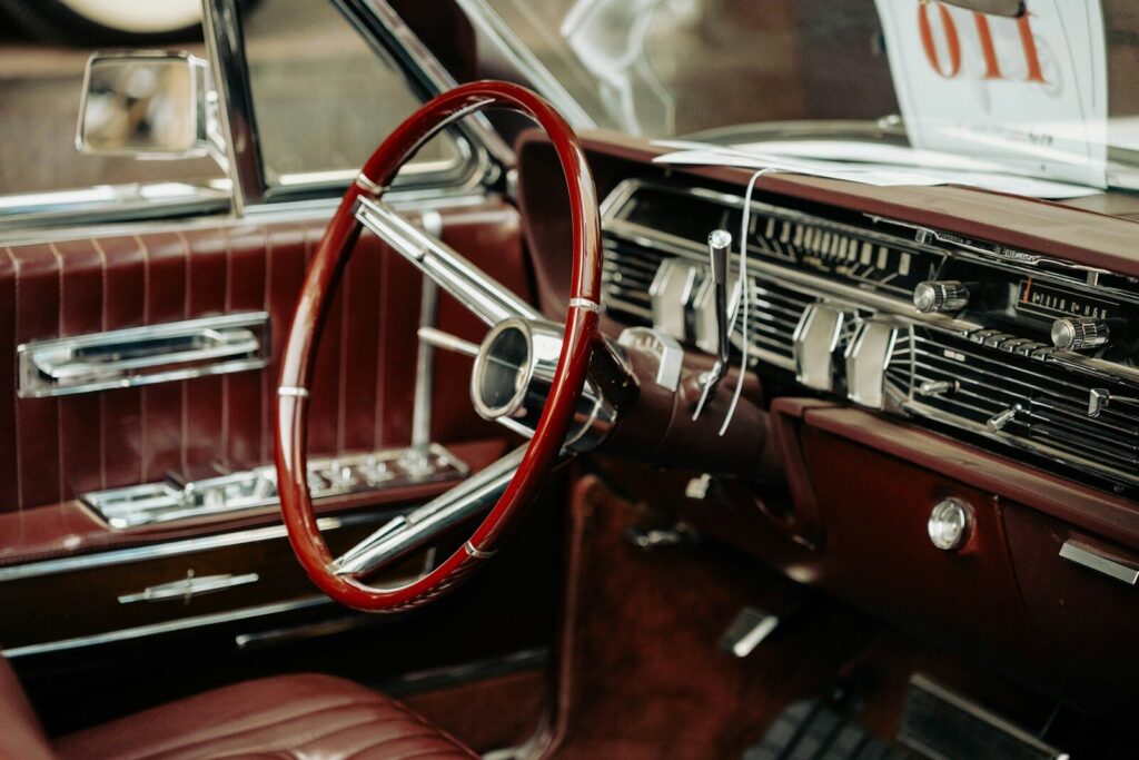 Interior of a vintage car with red leather seats.