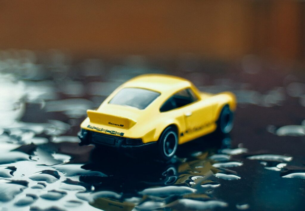 a yellow toy car sitting on top of a table