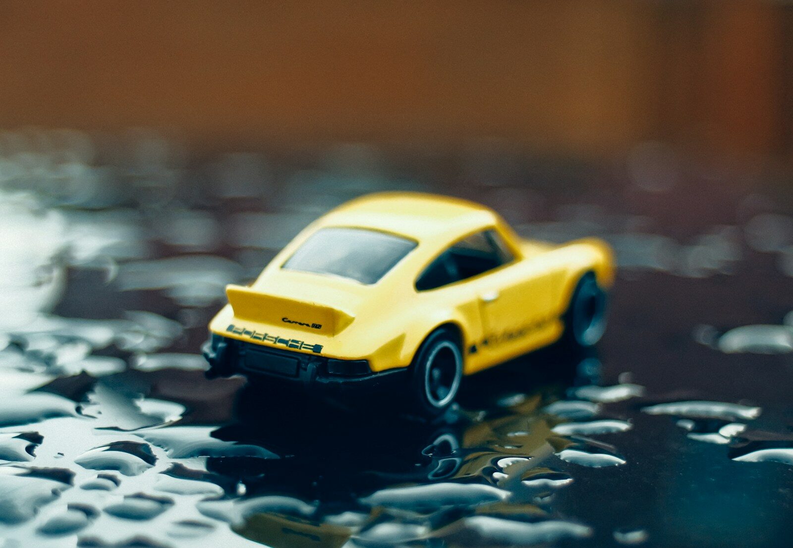 Photo by Nik a yellow toy car sitting on top of a table