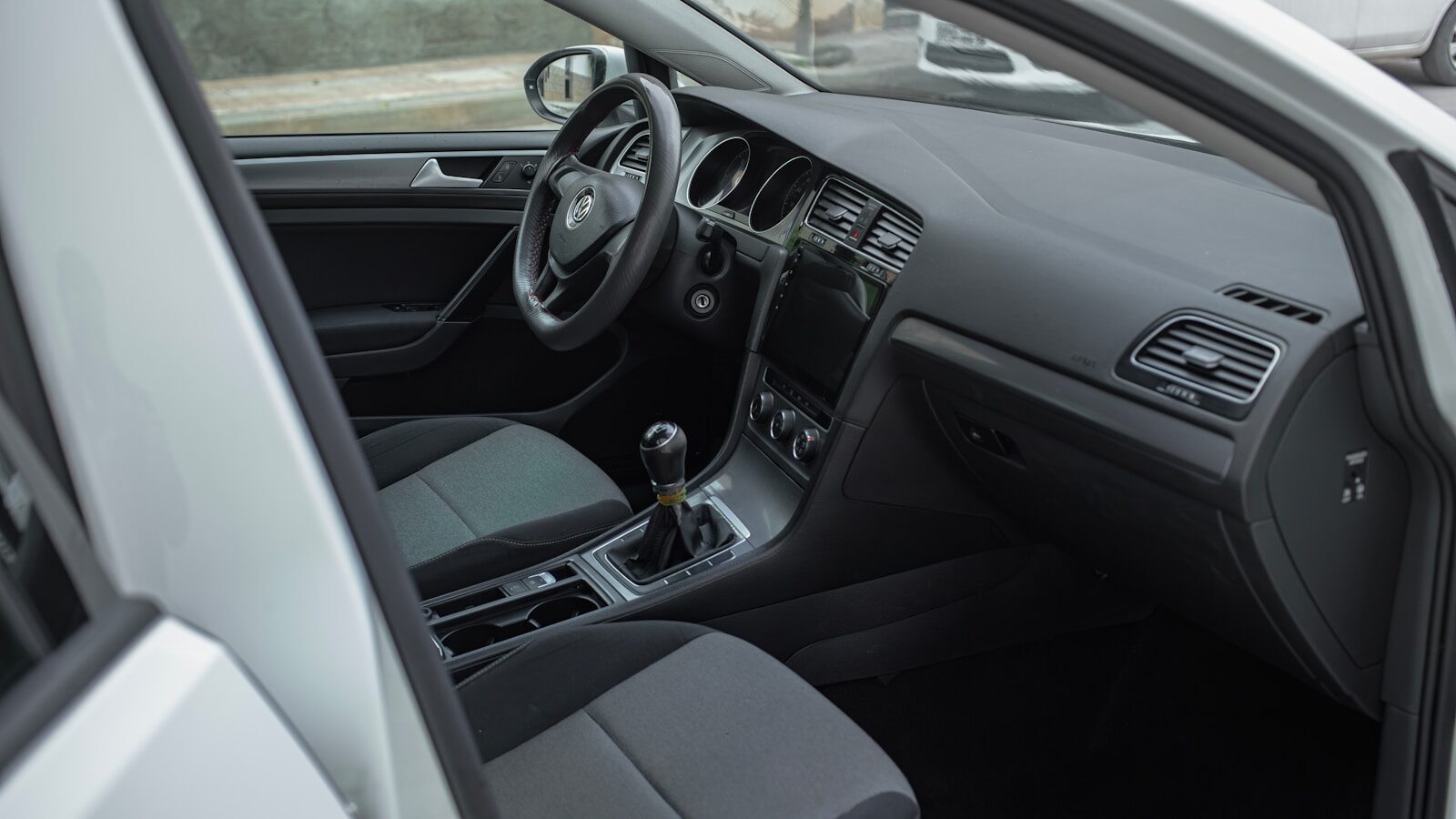 the interior of a car with a steering wheel and dashboard