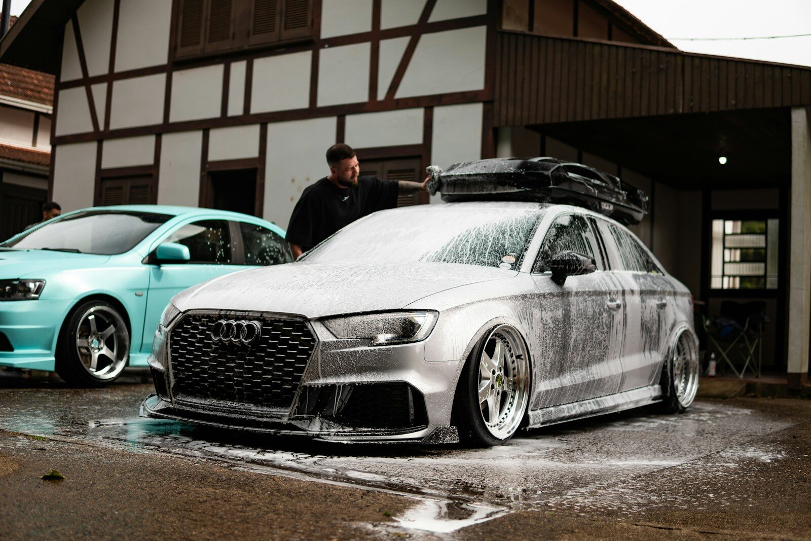 Photo by Willian Cittadin Man washing a silver audi with foam